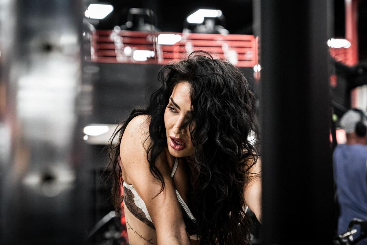 Female athlete mid hair flip between sets